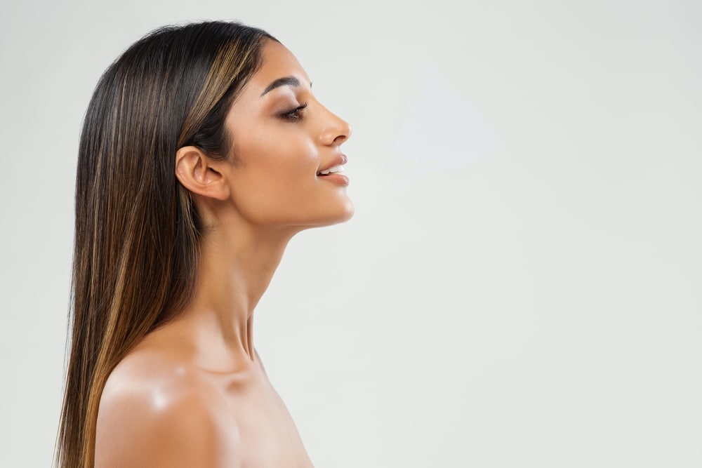 Beautiful woman's side profile after a subtle preservation rhinoplasty