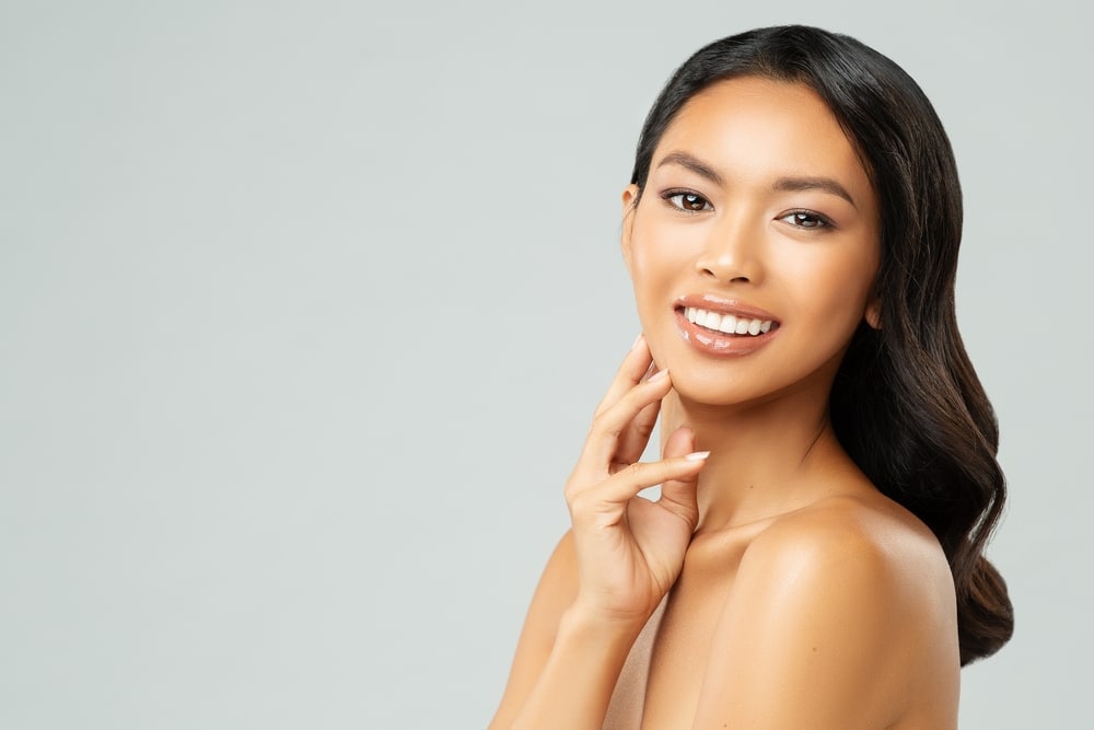 Beautiful woman smiles after Botox and fillers before a holiday party