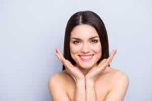 Brunette woman smiles widely after Letybo injections to smooth wrinkles in Detroit Brunette woman smiles widely after Letybo injections to smooth wrinkles in Detroit